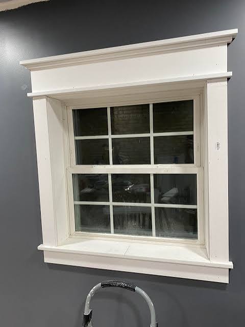 White-framed window on dark gray wall.