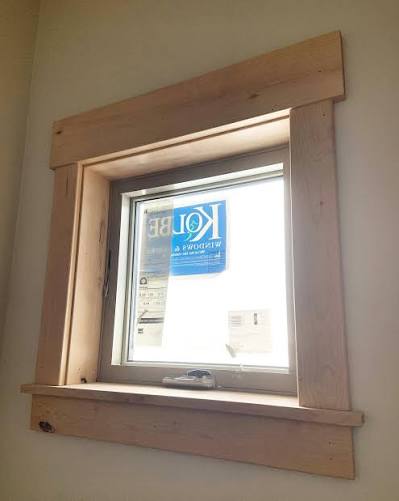 Wood-framed window with manufacturer's sticker visible.